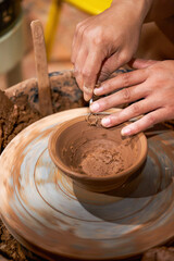 Craftsmen in pottery shop making clay pottery