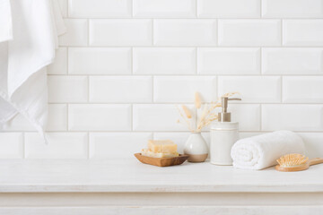 Fototapeta na wymiar Hygiene accessories on wooden table in bathroom over tile wall