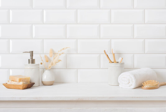 Tile wall and shelf in bathroom with various hygiene accessories