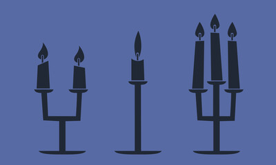 Set of candelabras with candles. Halloween design elements in black flat style.