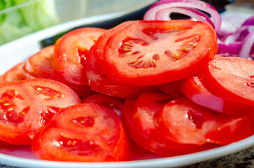 A plate of sliced tomatoes - Powered by Adobe