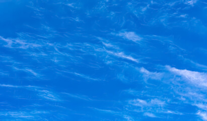 Clouds in dramatic blue sky.