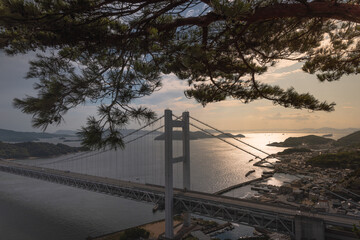 suspension bridge over the sea as a connection between islands.sunset on the great seto bridge.