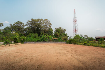 Empty dry cracked swamp reclamation soil, land plot for housing construction project with car tire...