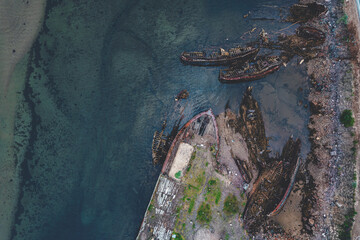 Cemetery of old ships in Teriberka Murmansk Russia, dramatic photo. Aerial top view