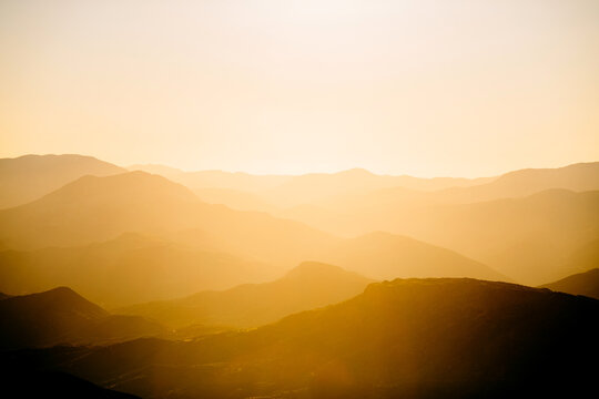 Beautiful orange sunset in mountains. Travel background.