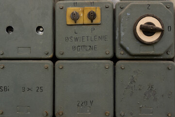 A set of old, unused cabinets with switches and electric fuses.
