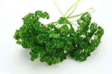 Obraz premium Fresh organic parsley herb isolated on white background. Close up