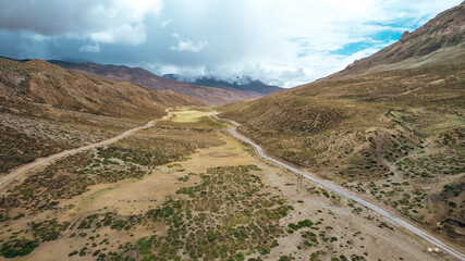 wide empty meadow field in Spiti Valley as storm approaches in Himachal Pradesh, aerial