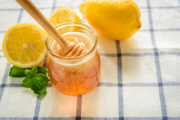 Honey with fresh Lemon with wooden honey dipper, honey dipper