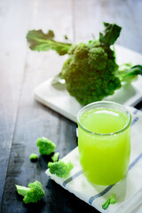 Glass of broccoli juice, broccoli Healthy drink on wood back ground