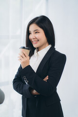 Two asian business woman work together to get the job done at the office.