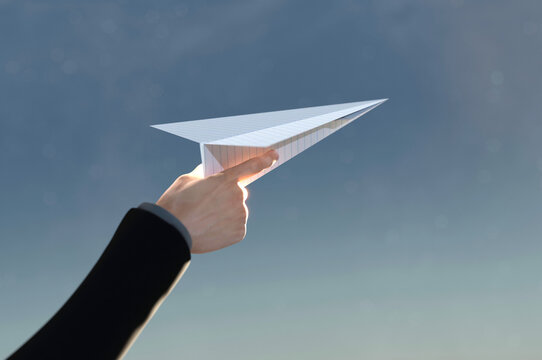 3D Illustration. 3D Rendering , Concept of business success  to the target , startup , creative idea . Business man hand on paper plane white flying on sky between cloud.