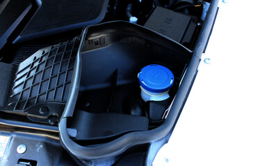 Modern SUV car Windshield Washer Reservoir. Close up Engine Washer Reservoir. Detailing engine parts.