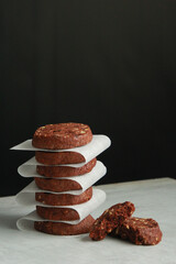 Pile of Chocolate Cookies on dark black background on a table.