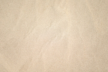 Fototapeta na wymiar Wet sea beach sand texture background with selective focus