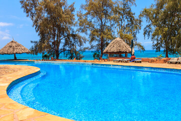 Swimming pool overlooking ocean. Tropical vacations concept
