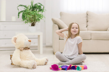 Photo of little girl posing for a photo with her toys.