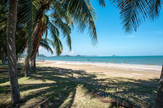 Unrecognizable tourists enjoy Sam Roi Yot beach south of Hua Hin. Hua Hin is a popular travel destination in Prachuap Khiri Khan province of Thailand.