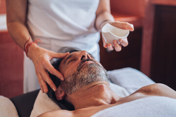 Adult man enjoying head massage