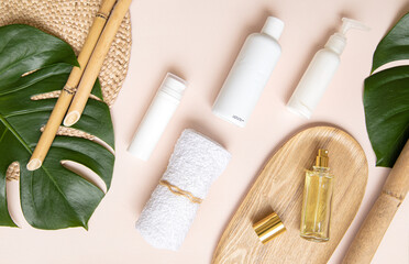 Fototapeta na wymiar Skin care concept with white bottle and palm leaves on tropical background.