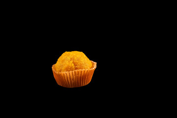 Orange Motichoor laddu isolated on black background
