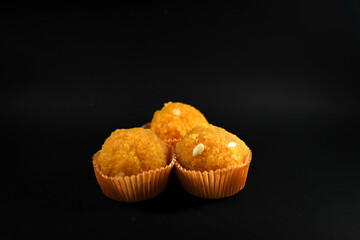 Orange Motichoor laddu isolated on black background