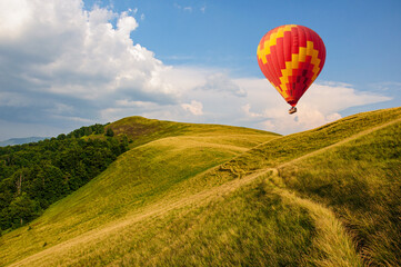 Naklejka premium A path winds along a grassy slope in the Carpathian Mountains, Ukraine