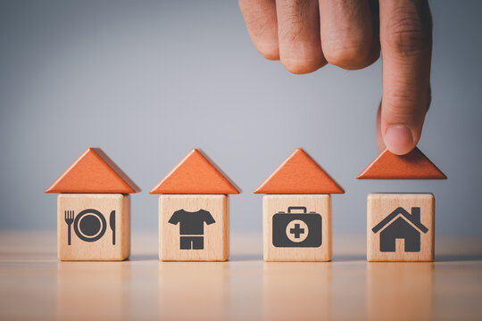 human hand placing cube with food Clothing, housing, medicine, four basic human needs concept.