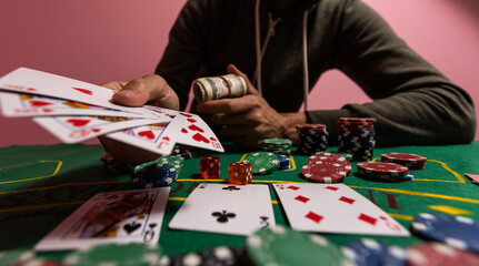 Casino, gambling and entertainment concept - stack of poker chips on a green table.