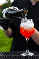 process of preparation of a cocktail Aperol spritz close-up.