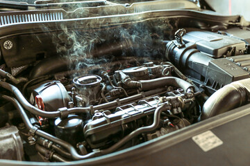 car engine overheating close up. vehicle engine in smoke. smoke or steam from a vehicle engine
