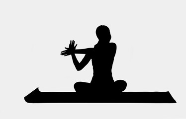 Silhouette of young attractive woman practicing yoga 