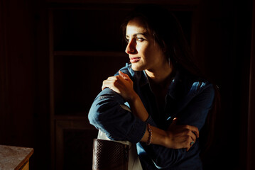 Woman in sunlight looking away