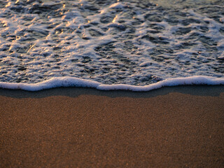 sea waves on the beach at sunset
