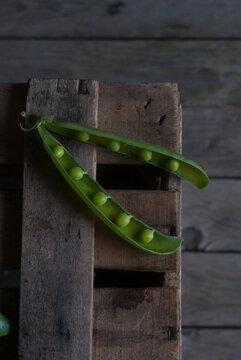 Closeup of pea pod on wood