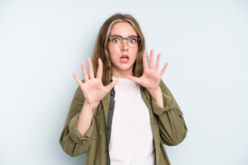 caucasian pretty woman feeling terrified, backing off and screaming in horror and panic, reacting...