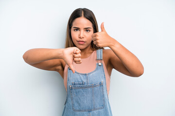 hispanic latin pretty woman feeling confused, clueless and unsure, weighting the good and bad in...