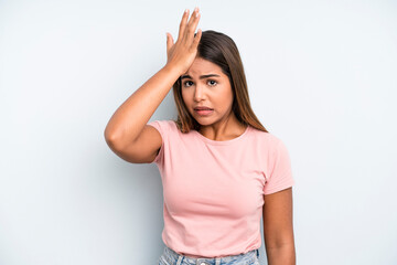 hispanic latin pretty woman raising palm to forehead thinking oops, after making a stupid mistake...