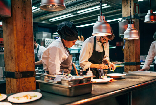 Coworking cooks serving food on counter