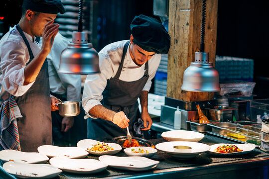 Coworking cooks serving food on counter