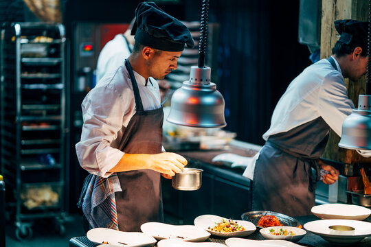 Coworking cooks serving food on counter