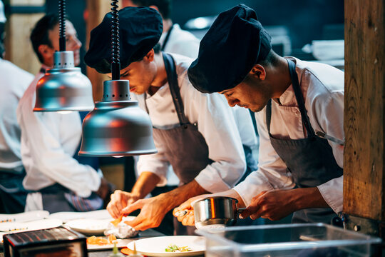 Coworking cooks serving food on counter