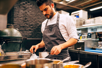 Adult man cooking in restaurant