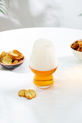 One Beer in glass with foam snack light surface copy space food