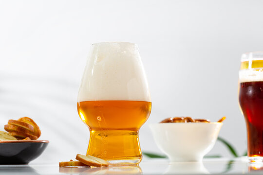 Beer in glass with foam snack light surface