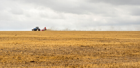 Obraz premium Tractor on a stubble field