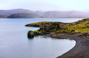 Bay in whale fjord (Hvalfjörður) with black lava sand, Iceland