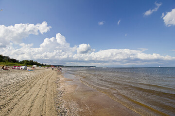 seascape. sandy seashore, sea and cloudy sky