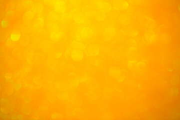 Background texture of shiny golden bokeh. Beautiful festive christmas background for greeting design. Nacreous sparkling yellow texture.